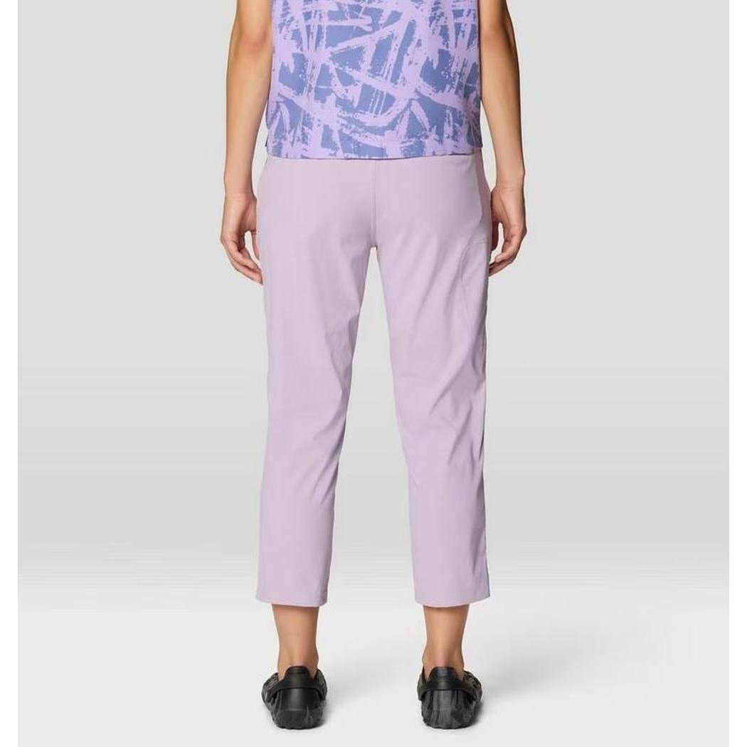 Back view of the Mountain Hardwear Women's Dynama Crop in Atmospheric, showing cropped fit and model wearing black shoes against a plain background.