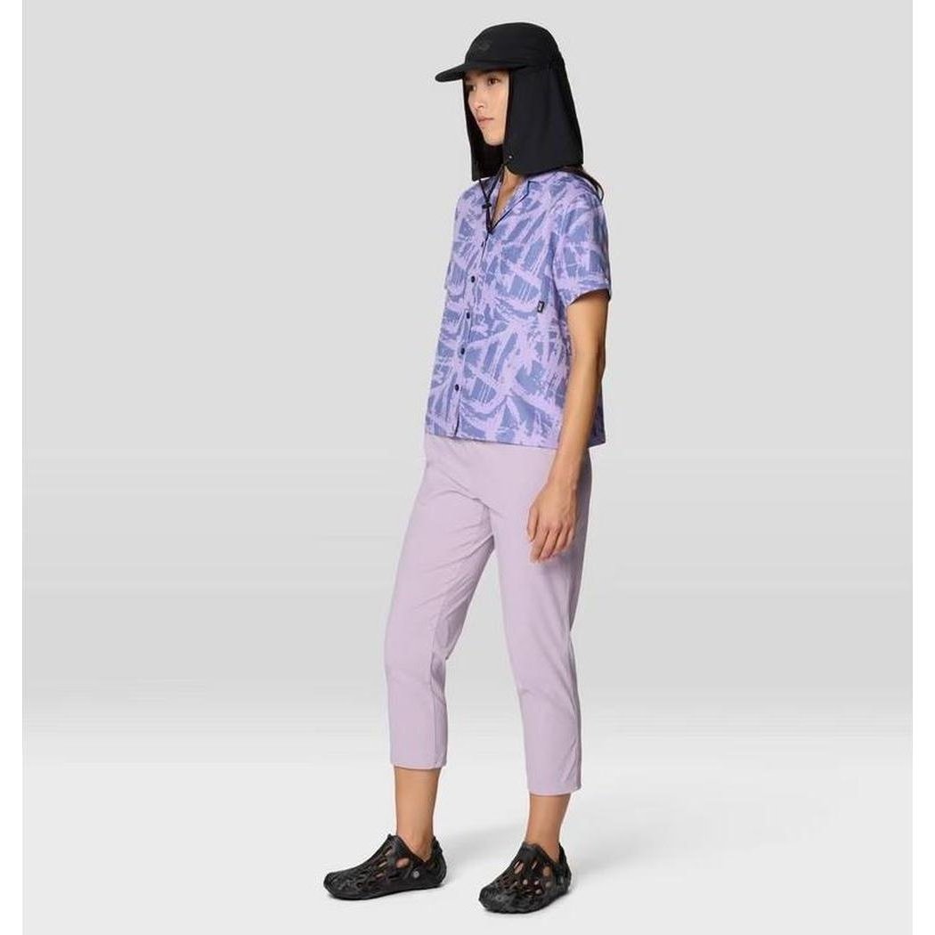 Side view of the Mountain Hardwear Women's Dynama Crop in Atmospheric showing the short sleeve top and cropped pants on a model against a light gray background.