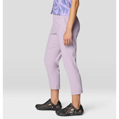 Side view of the Mountain Hardwear Women's Dynama Crop in Atmospheric showing the cropped length and black shoes against a light background.