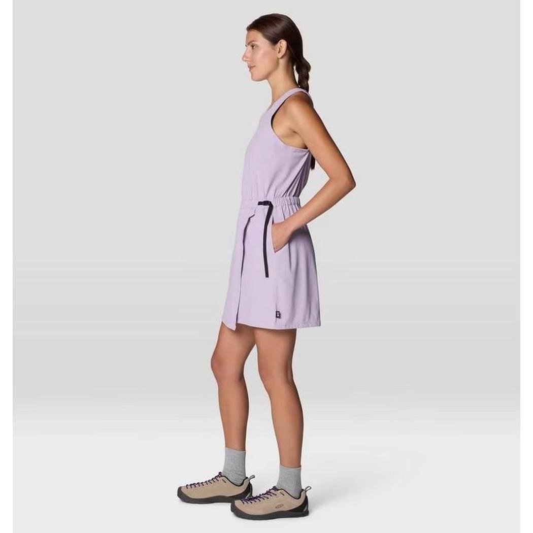 Side view of the Mountain Hardwear Women's Dynama Dress in Atmospheric color showing the model wearing it against a light gray background.