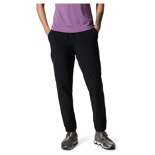 A front view of the Mountain Hardwear Women's Yumalina Active Pull-On Lined Jogger in Black, showing the model wearing it with hands in pockets against a white background.