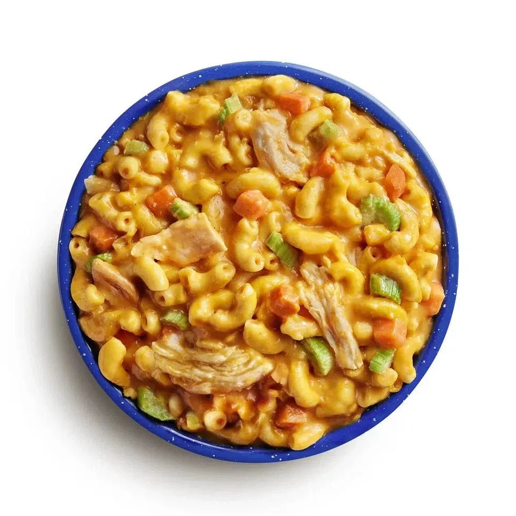 Top-down view of the Mountain House Buffalo Style Chicken Mac and Cheese in a blue bowl against a white background.