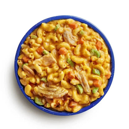 Top-down view of the Mountain House Buffalo Style Chicken Mac and Cheese in a blue bowl against a white background.