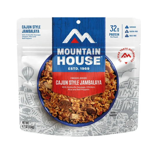 A front view of the Mountain House Cajun Style Jambalaya backpacking food package showing the freeze-dried meal in a blue bowl against a white background.