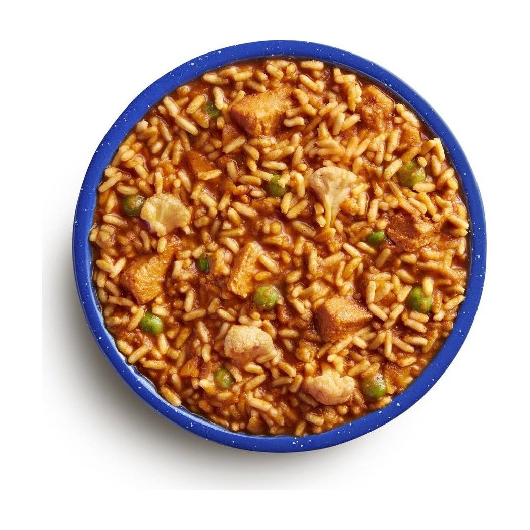 A top-down view of the Mountain House Chicken Tikka Masala (GF) in a blue bowl, showing rice, chicken, and peas.