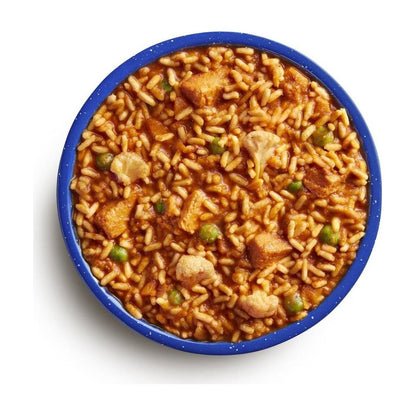 A top-down view of the Mountain House Chicken Tikka Masala (GF) in a blue bowl, showing rice, chicken, and peas.