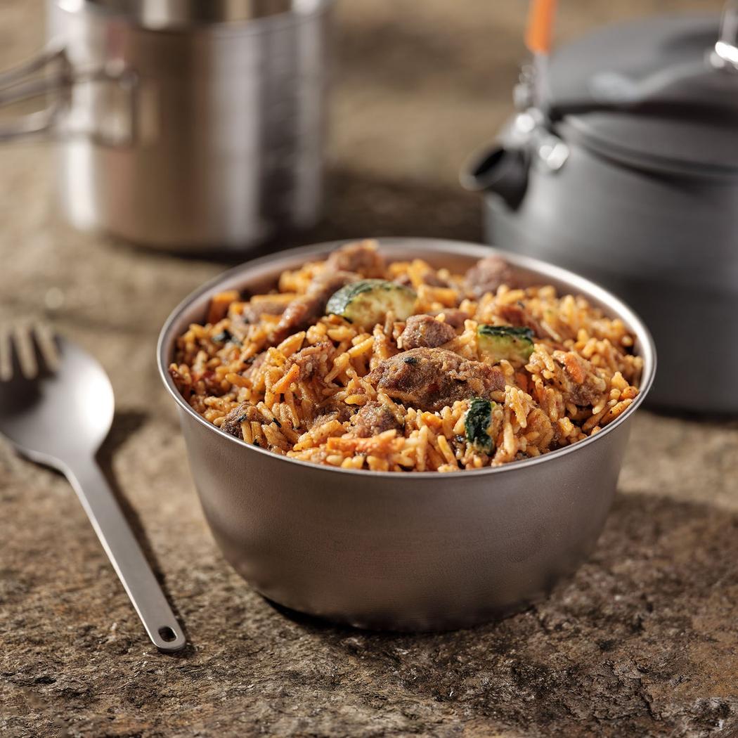 A stainless steel bowl of Mountain House Korean Inspired Beef in Bulgogi Sauce (GF) sits on a granite countertop with a fork and pot in the background.