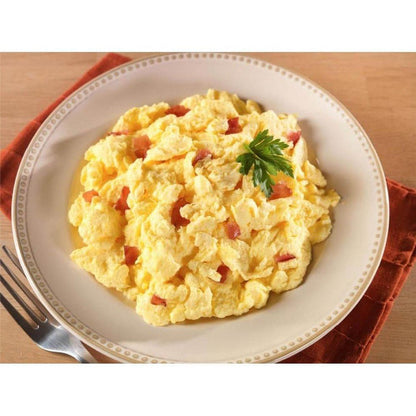 A plate of Mountain House Scrambled Eggs with Bacon on a red napkin with a fork nearby.