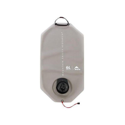 A front view of the MSR DromLite 2L hydration bag in charcoal/graphite with a black cap and red cord against a white background.