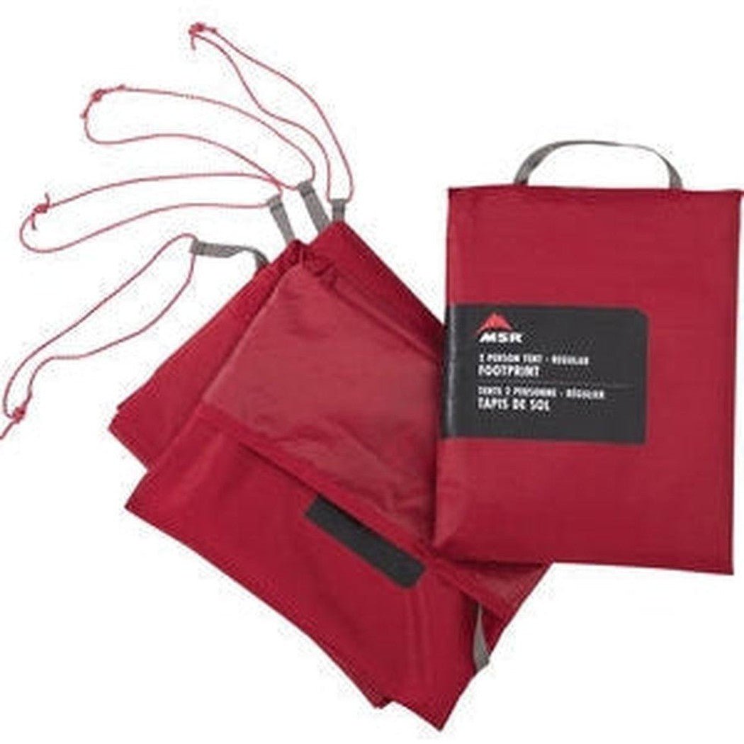 Red MSR Footprint Universal tent footprint laid out with red drawstrings and a matching red storage bag on a white background.