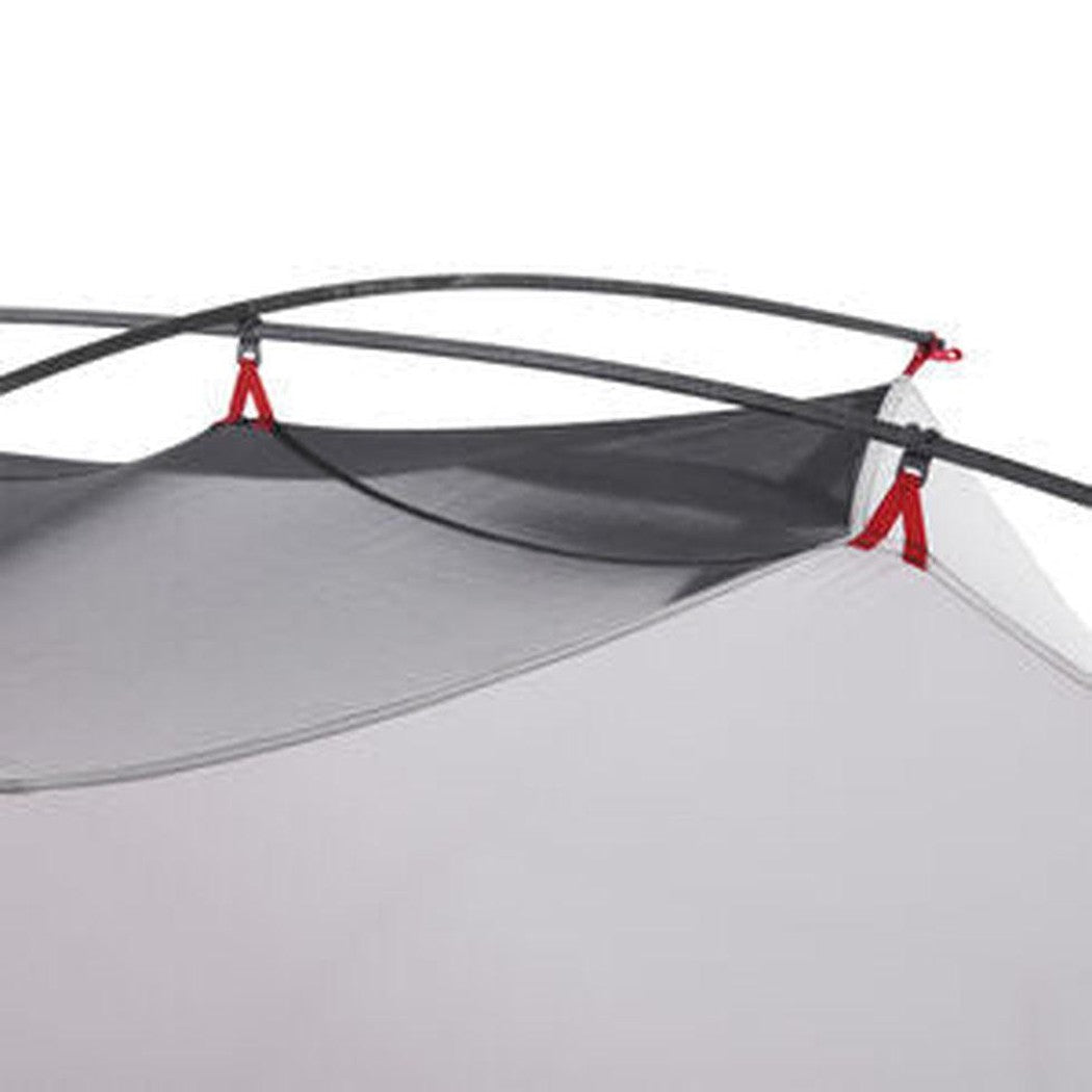 The MSR Hubba Hubba 2 Tent V9 shows the mesh and gray fabric with red tie-downs and black poles against a white background.