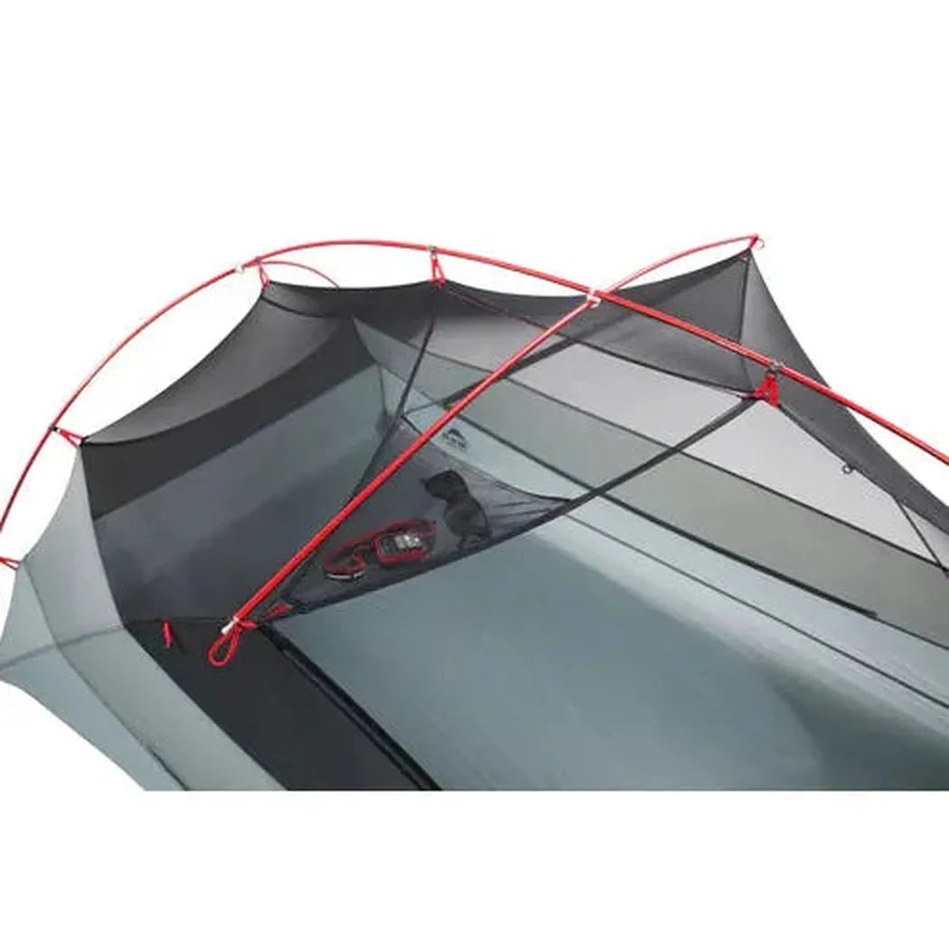 The MSR Hubba Hubba LT 2P Tent in Charcoal/Graphite is shown from above with red poles and a mesh interior, set against a white background.