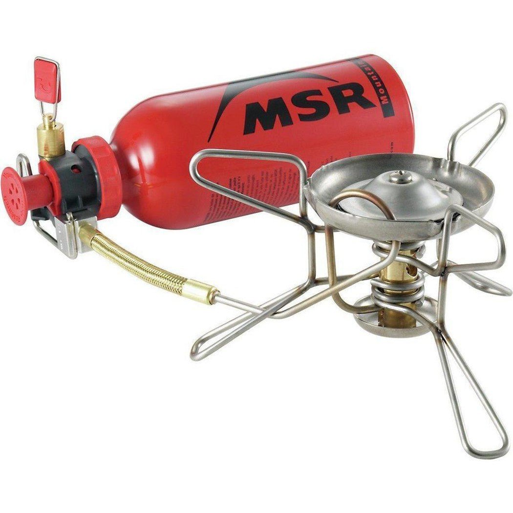 A red MSR WhisperLite Stove with a metal burner and tripod legs, shown from a front angle against a white background.
