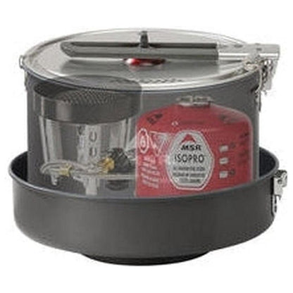 A top-down view of the MSR WindBurner Combo System in Charcoal/Graphite showing the red MSR IsoPro fuel canister and transparent pot inside the black cooking base.