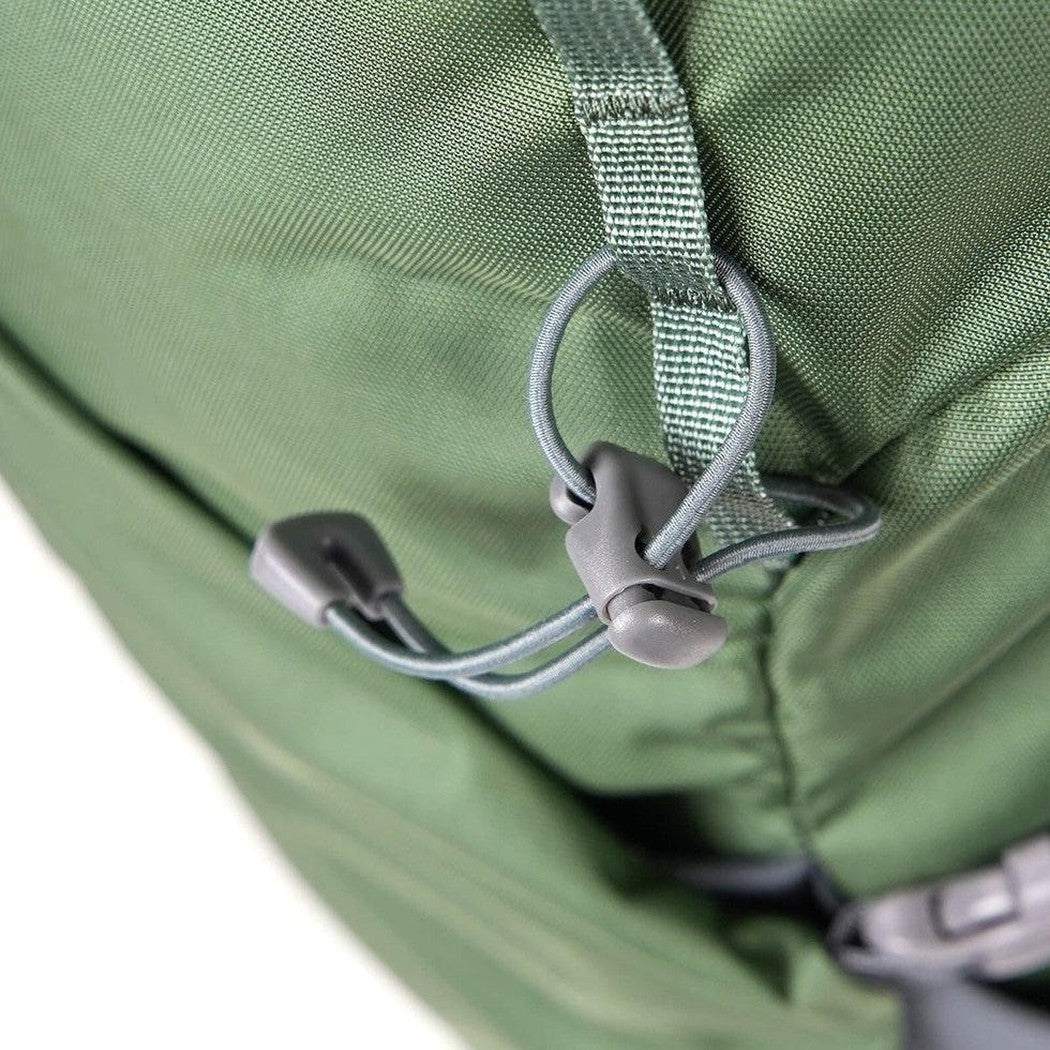 A close-up of the Mystery Ranch Men's Coulee 50 backpack in Noble Fir showing the cord lock and strap against a white background.