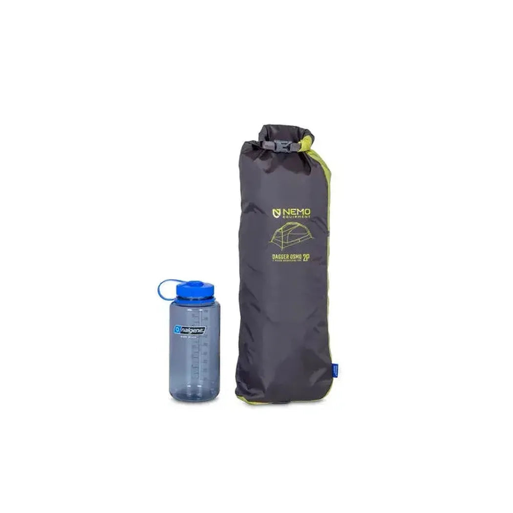 A side view of the NEMO Dagger OSMO Lightweight Backpacking 2p Tent in Charcoal/Graphite next to a blue water bottle on a white background.