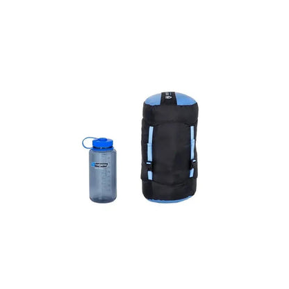 A side view of the NEMO Disco Women's Endless Promise 30 Down in Blue Horizon next to a water bottle against a white background.