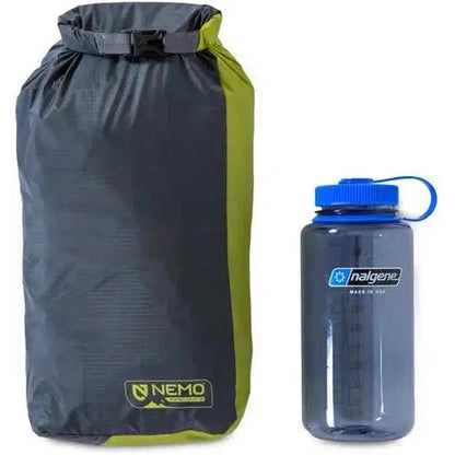 A front view of the NEMO Hornet OSMO 2P tent bag next to a Nalgene water bottle on a white background.