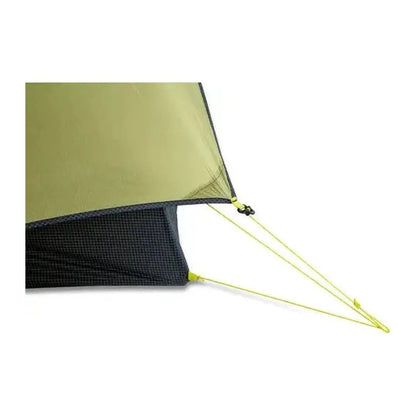 A close-up of the NEMO Hornet OSMO Ultralight Backpacking Tent showing its yellow guylines and mesh floor against a white background.