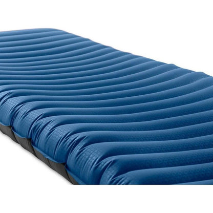 A close-up side view of the NEMO Quasar 3D Insulated sleeping pad with its blue 3D wave pattern against a white background.