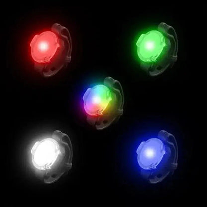 Five Nite Ize GoLit Rechargeable Visibility Lights in red, green, multicolor, white, and blue against a black background.