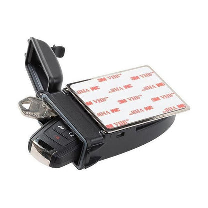 A top-down view of the Nite Ize HideOut XL Magnetic Key Box with a 3M adhesive backing and a car key inside, set against a white background.