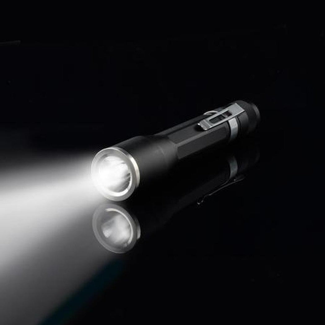 A side view of the Nite Ize Inova X2 LED Flashlight showing the on/off switch and bright beam against a black background.