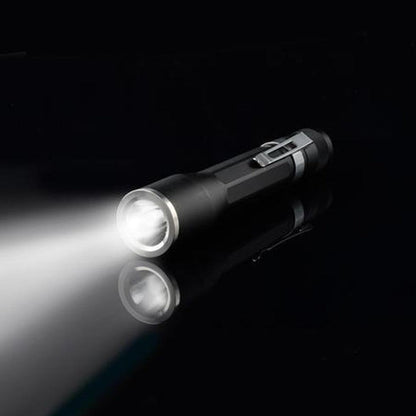 A side view of the Nite Ize Inova X2 LED Flashlight showing the on/off switch and bright beam against a black background.