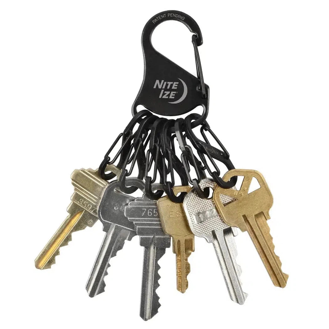 A black Nite Ize KeyRack Steel S-Binder holds six keys, displayed against a white background.