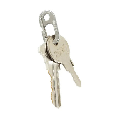 A close-up of the Nite Ize KeyRing MicroLink with two keys, showing the carabiner attachment and a white background.