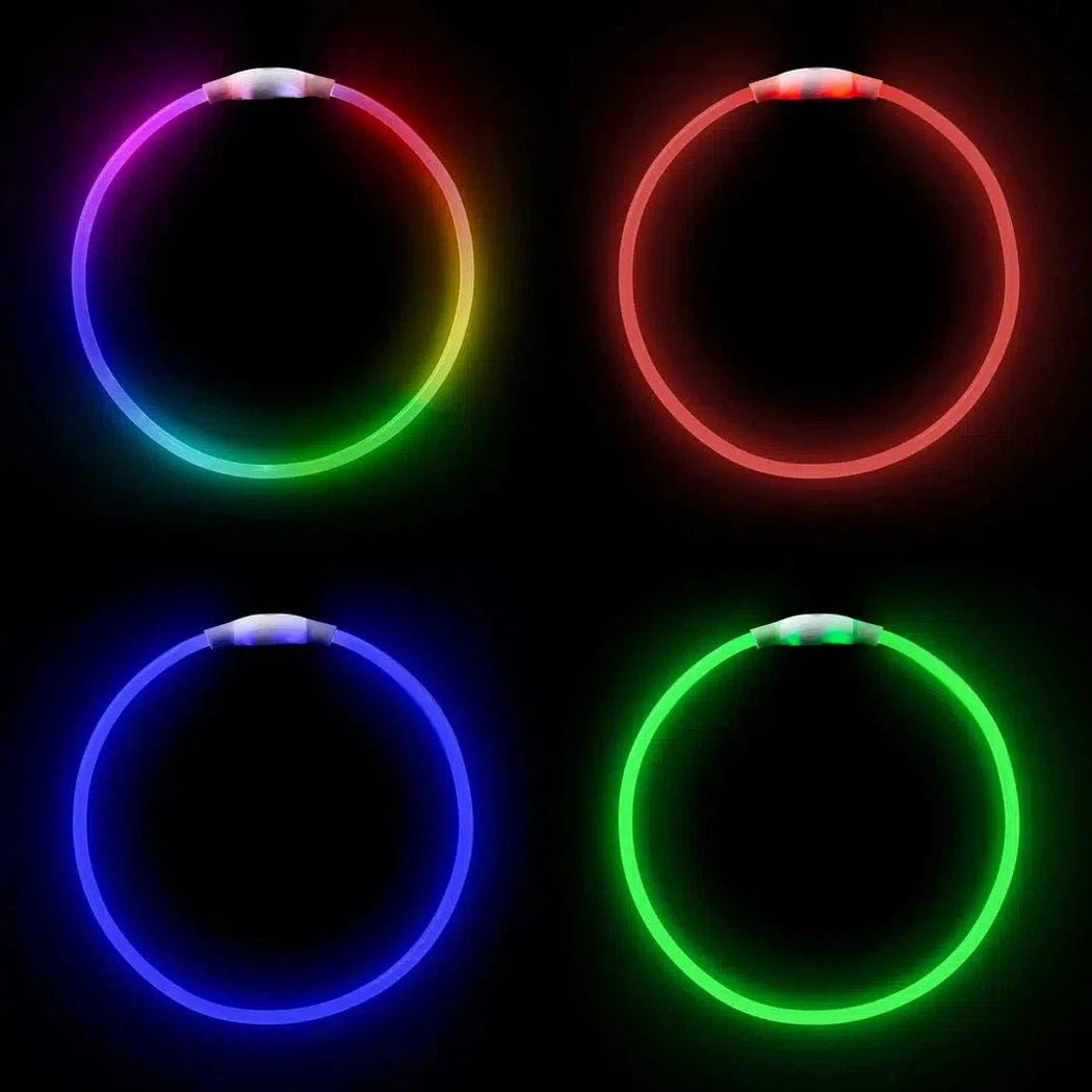 Four Nite Ize NiteHowl Bandana Rechargeable LED Safety Necklaces in different colors against a black background.