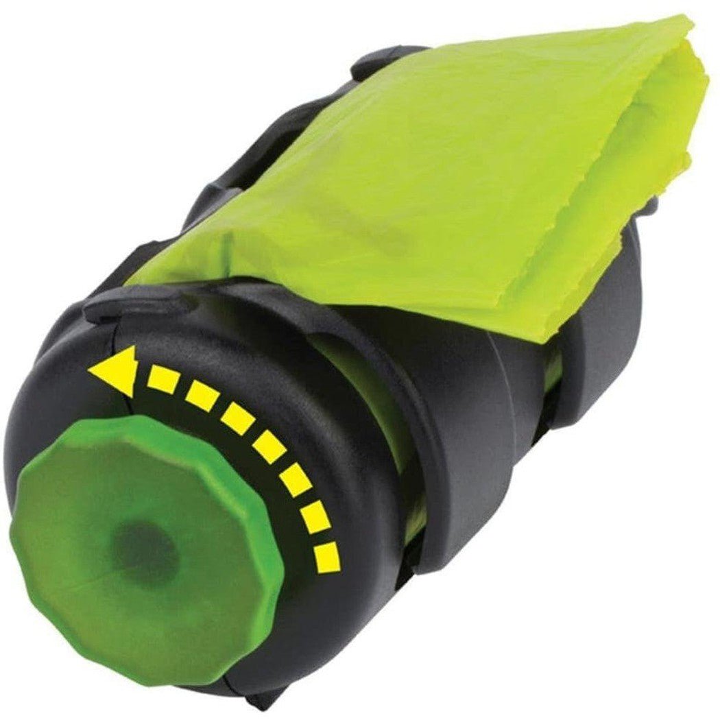 A close-up of the Nite Ize Pack-a-poo Dispenser with a bright green bag and a black base, showing the green knob and yellow directional markings.