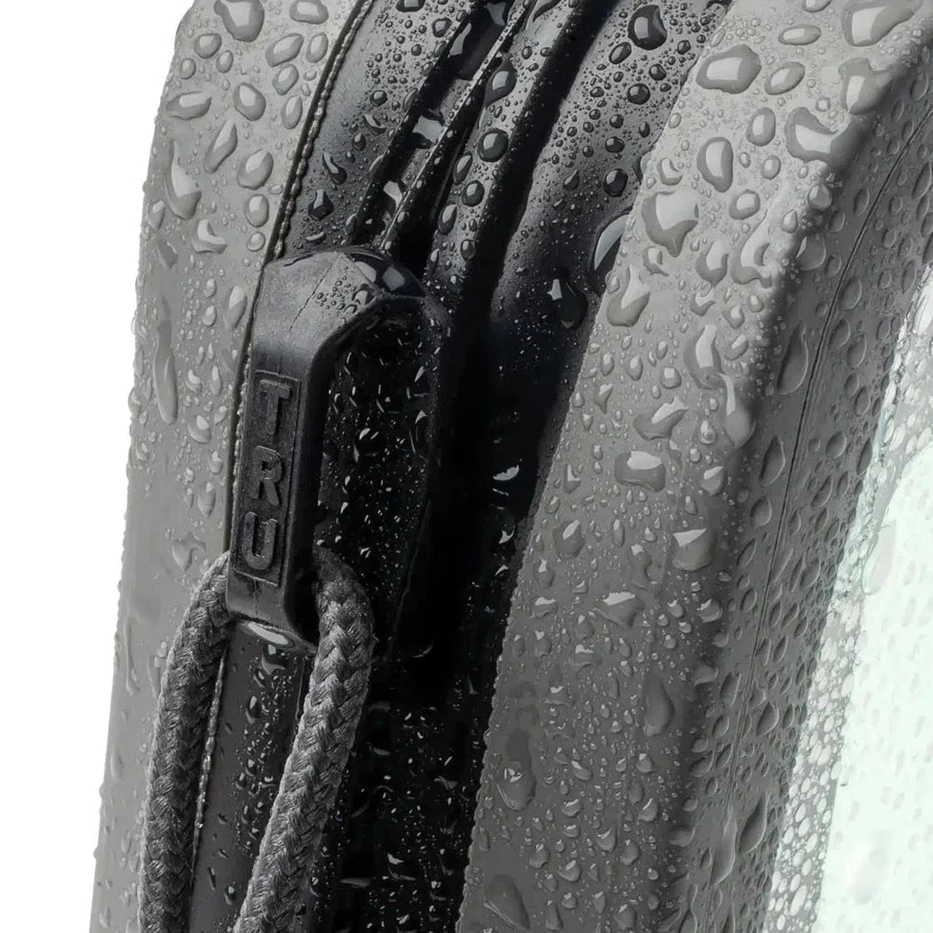 A close-up of the Nite Ize RunOff Waterproof Hip Pack in Black showing the zipper and water droplets on the fabric.