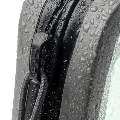 A close-up of the Nite Ize RunOff Waterproof Hip Pack in Black showing the zipper and water droplets on the fabric.