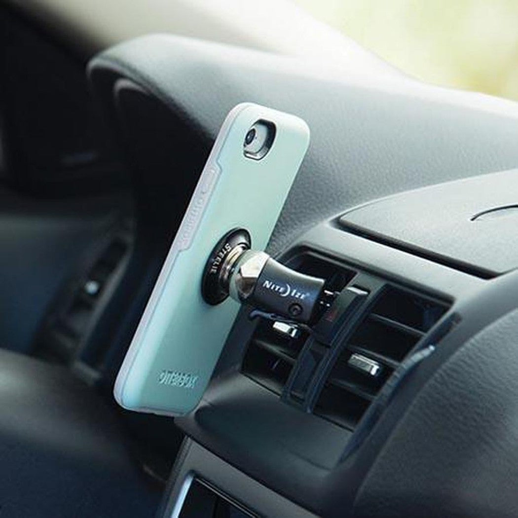 A light blue Nite Ize Steelie Orbiter Vent Kit mounted on a car's air vent, showing the phone holder and magnetic mount.