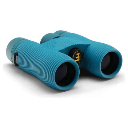 Side view of the Nocs Provisions Field Issue Waterproof Binoculars in Corsican Blue showing the textured grip and central focus wheel against a white background.