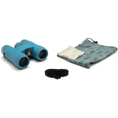 Side view of the Nocs Provisions Field Issue Waterproof Binoculars in Corsican Blue with a cleaning cloth and pouch on a white background.