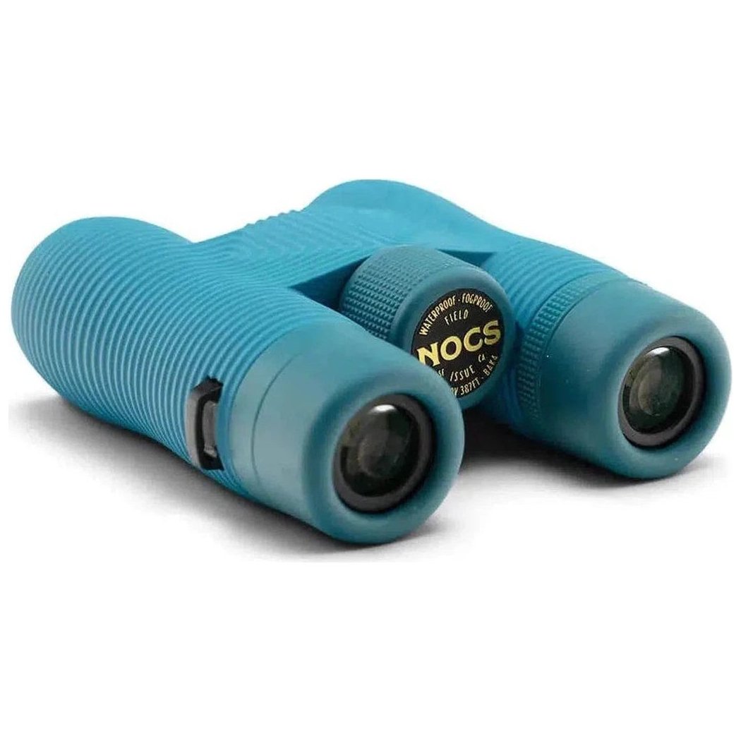 Side view of the Nocs Provisions Field Issue Waterproof Binoculars in Corsican Blue with a white background.
