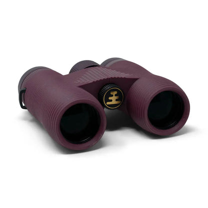 Side view of the Nocs Provisions Field Issue Waterproof Binoculars in Corsican Blue showing the central focus wheel and black eyecups against a white background.