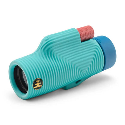 A side view of the Nocs Provisions Zoom Tube Monocular in Tar Pit Black with a textured grip and a blue eyecup against a white background.