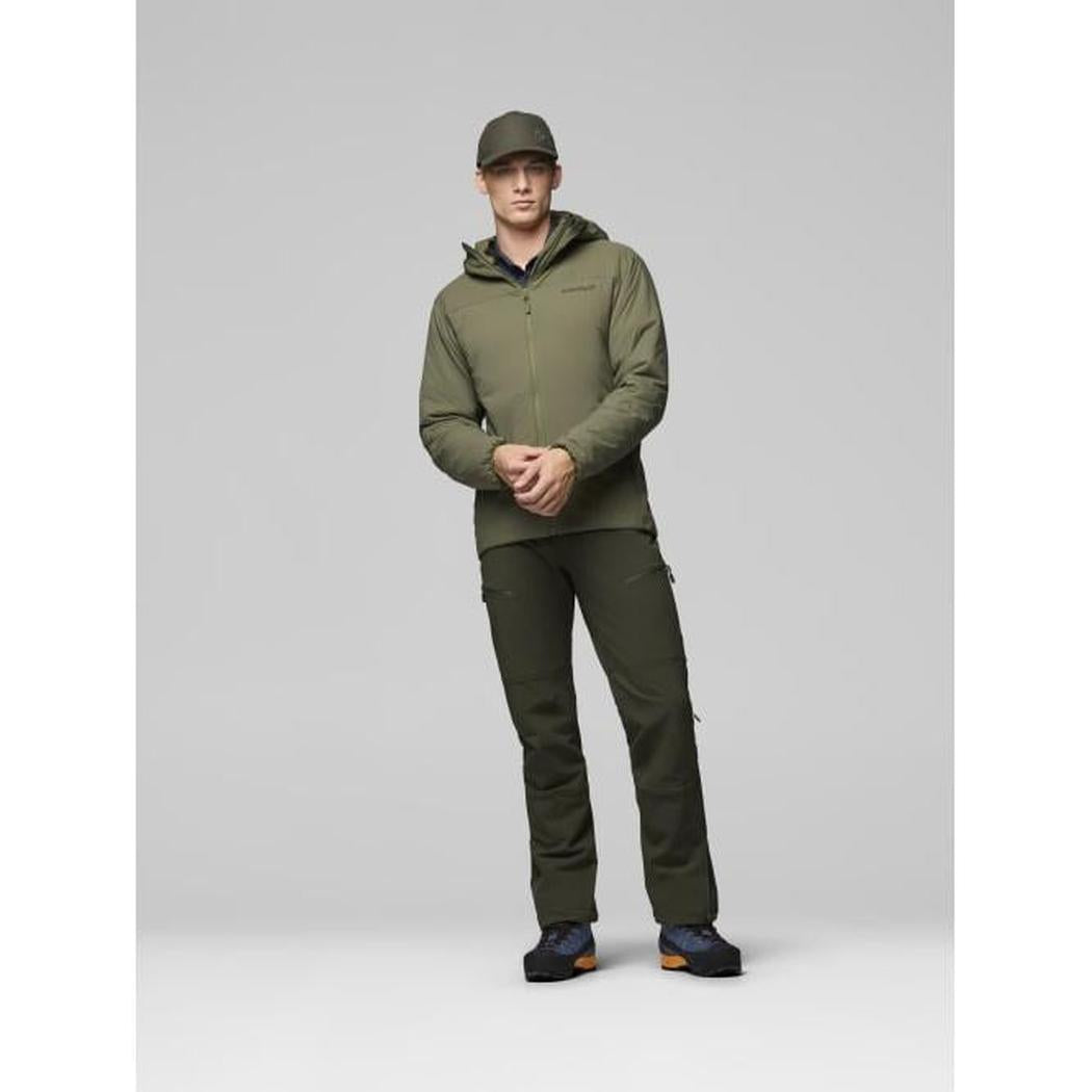 A model wearing the Norrona Men's Femund Thermo60 Zip Hood in Indigo Night stands against a light gray background.