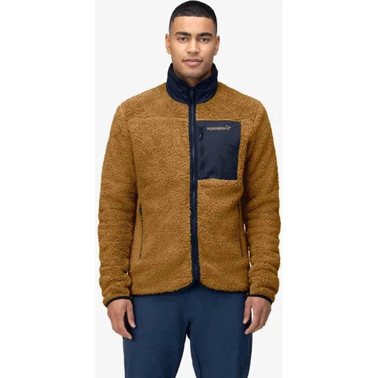 A front view of the Norrona Men's Femund Warm3 Jacket in Camelflage with a dark blue chest pocket and collar, on a model wearing dark blue pants against a white background.