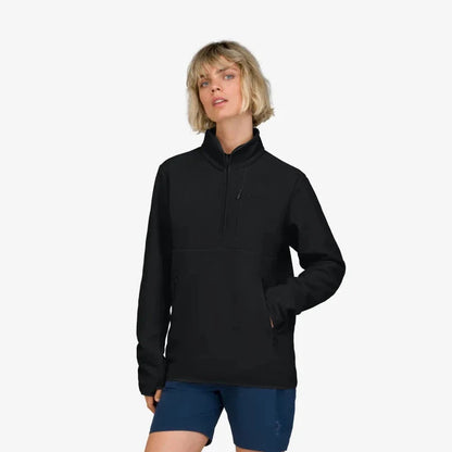 A front view of the Norrona Unisex Femund Warm 2 Halfzip in Caviar Black on a model wearing blue shorts against a white background.