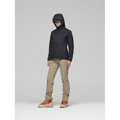 A model wearing the Norrona Women's Femund Thermo60 Zip Hood in Caviar Black stands against a light gray background.