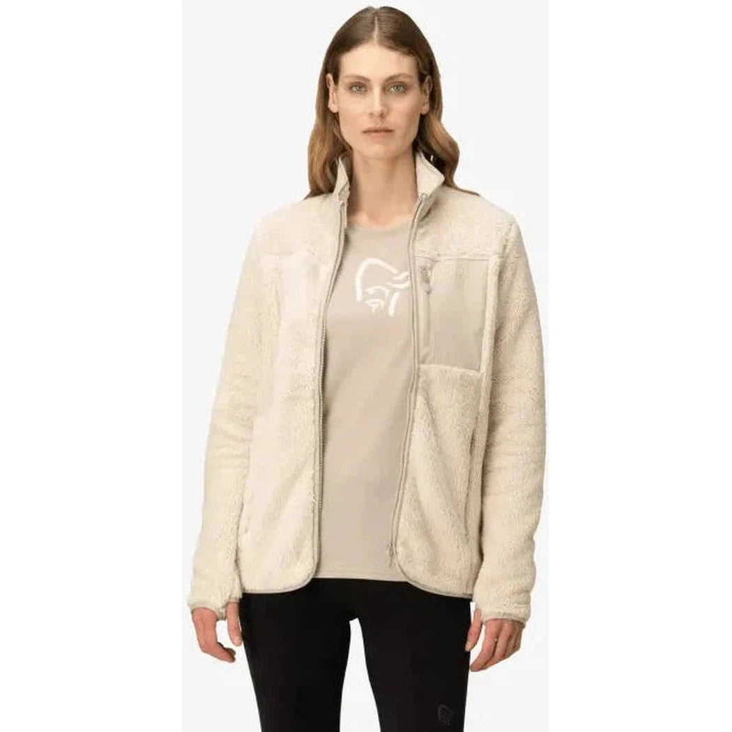 A front view of the Norrona Women's Femund Warm3 Jacket in Oatmeal on a model wearing black pants against a white background.