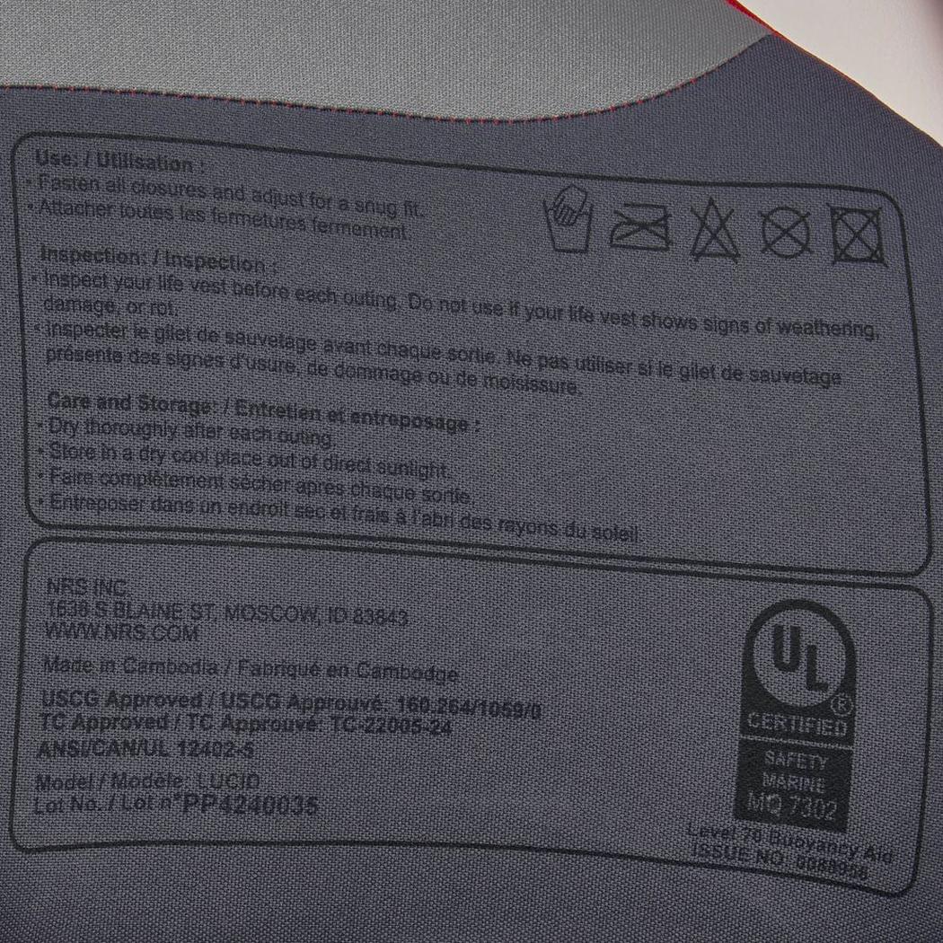 A close up of the NRS Lucid PFD in Red showing the care and inspection instructions on the label.