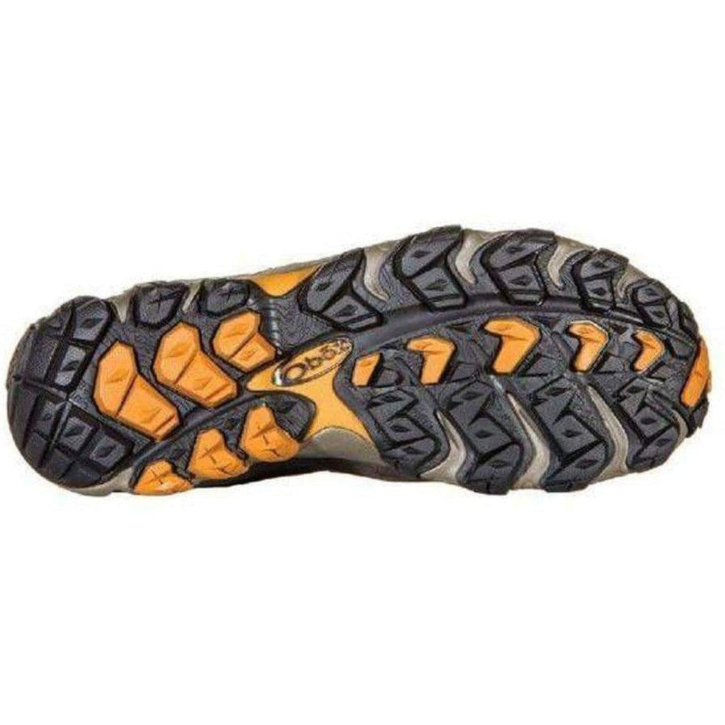 The sole of the Oboz Men's Bridger Mid B-DRY boot, showing its rugged tread pattern and orange accents, against a plain white background.
