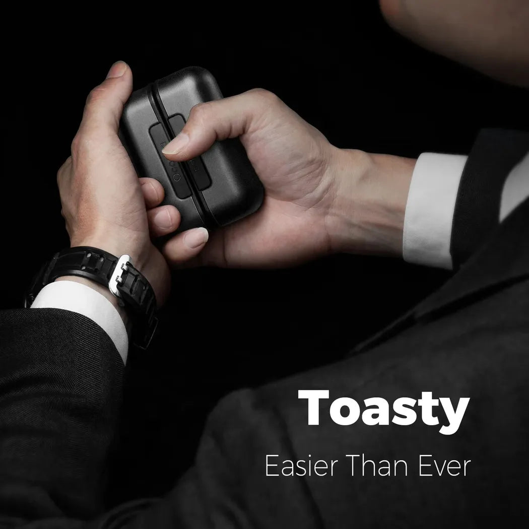 A person in a black suit holds the black Ocoopa UT2s Rechargeable Hand Warmer against a dark background.