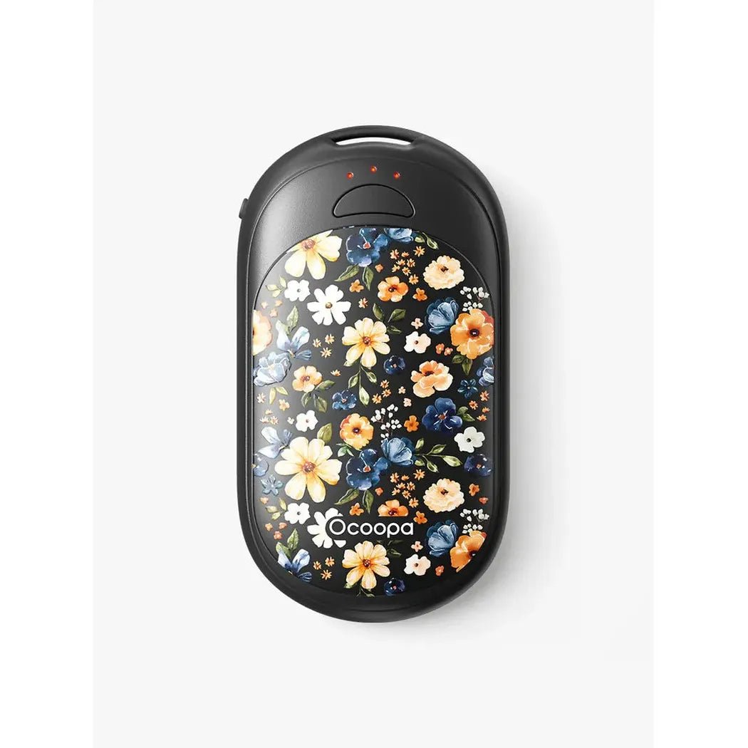 A top-down view of the Ocoopa UT3 Lite Magnetic Rechargeable Hand Warmers in Black with a floral design and red indicator lights on a white background.