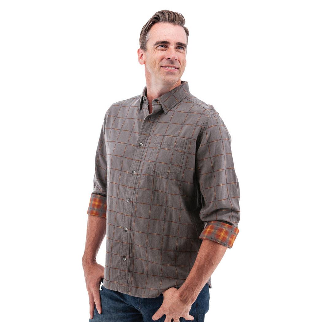 A man wearing the Old Ranch Men's Chase Shirt 25 in Blue Skies stands against a white background with rolled-up sleeves.